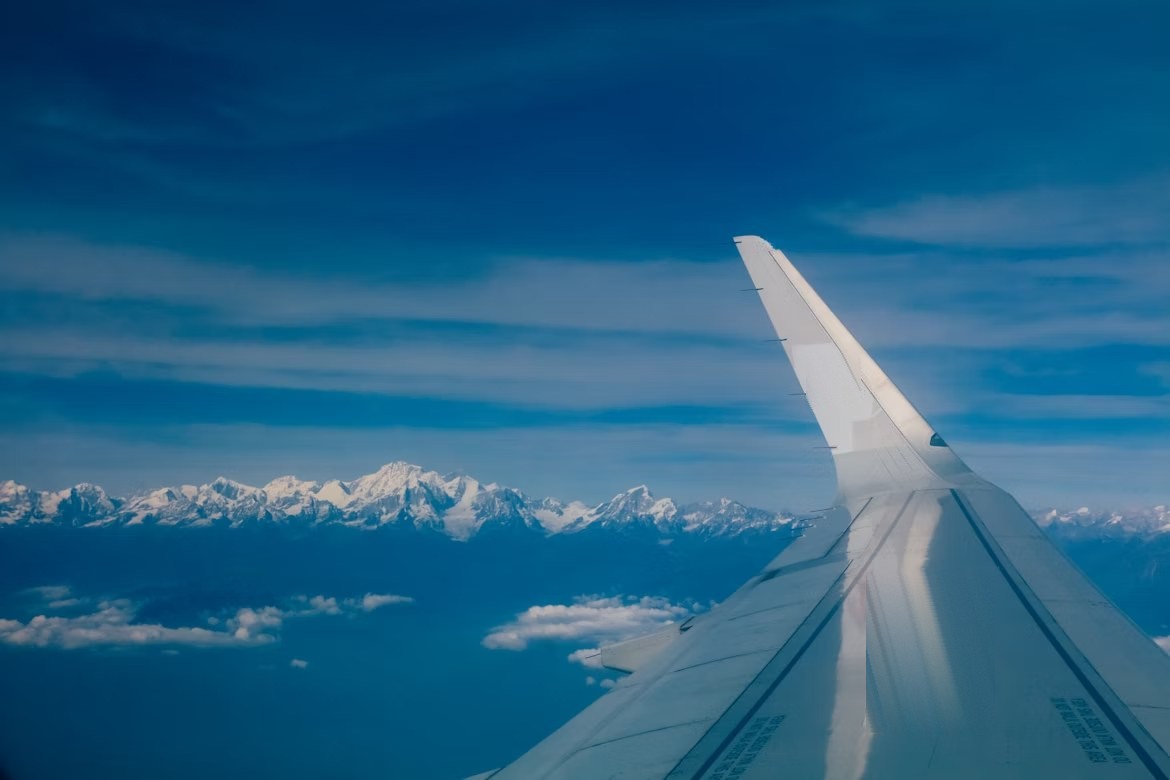 The wing of an aircraft above the Himalaya on a clear morning